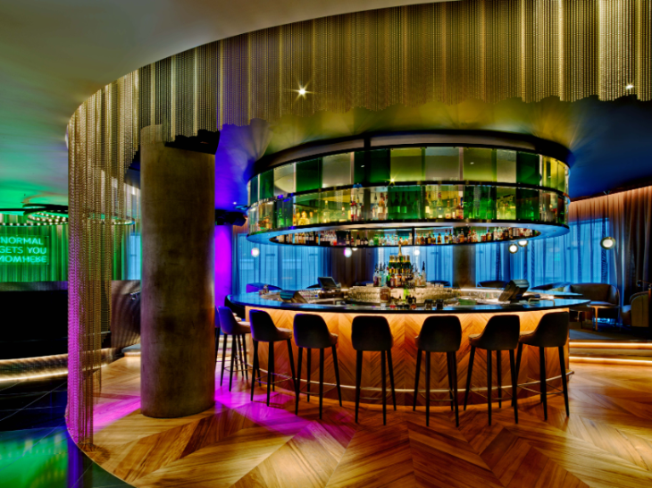 A hotel bar, illuminated with colourful lighting