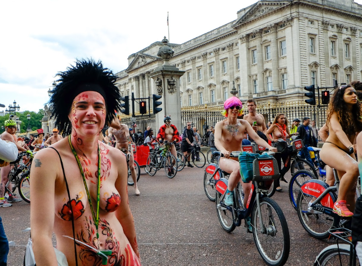 Nude cyclists riding past Buckingham Palace