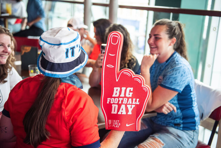 Football fans, one with a big foam hand "Big football day"