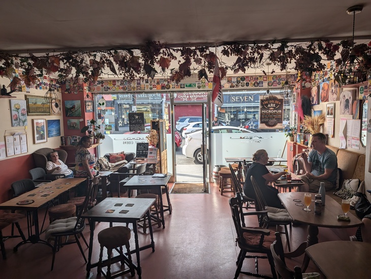 A micropub with hops hanging from the ceiling