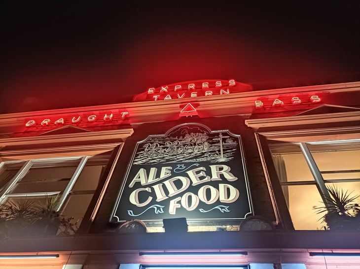 Neon red lights on the front of the pub