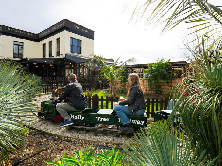 A miniature train in a beer garden