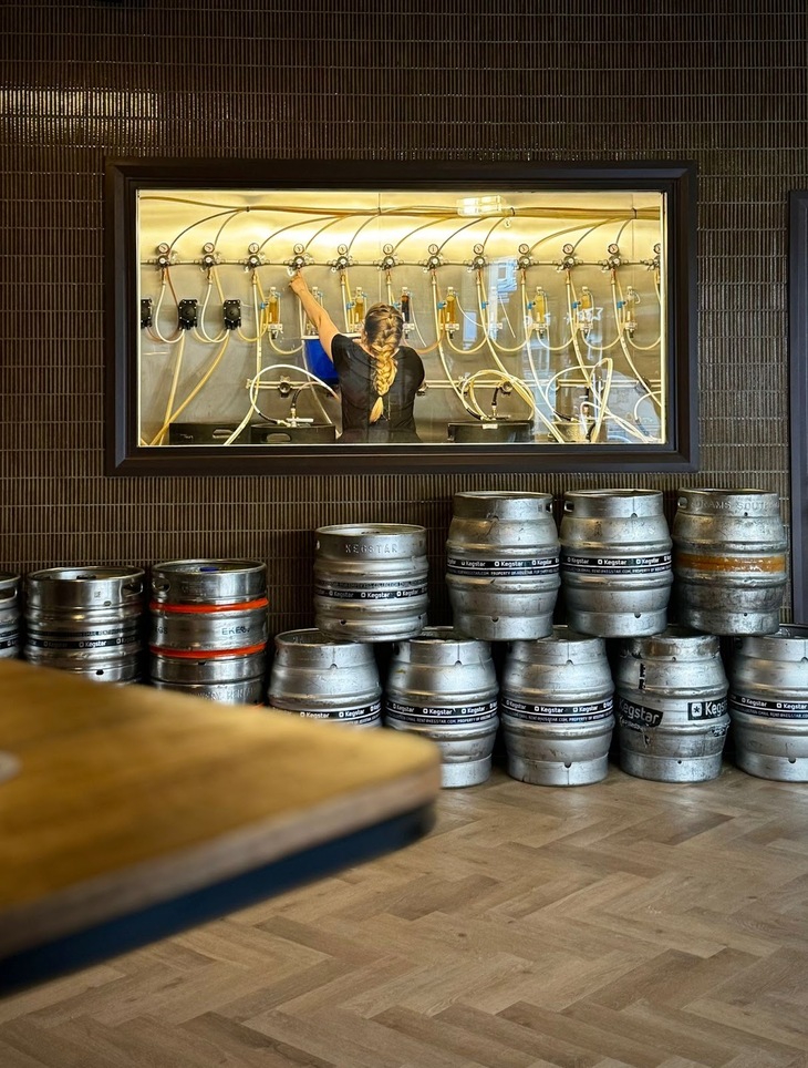 Beers being poured from a mass of pipes