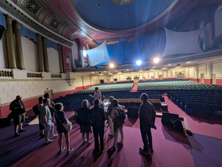 The tour group standing on the stage