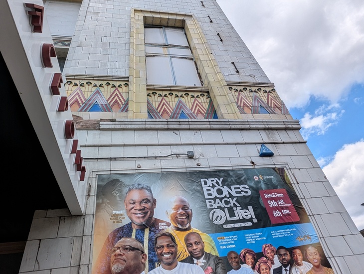 Details on the front of the cinema, and posters for the church