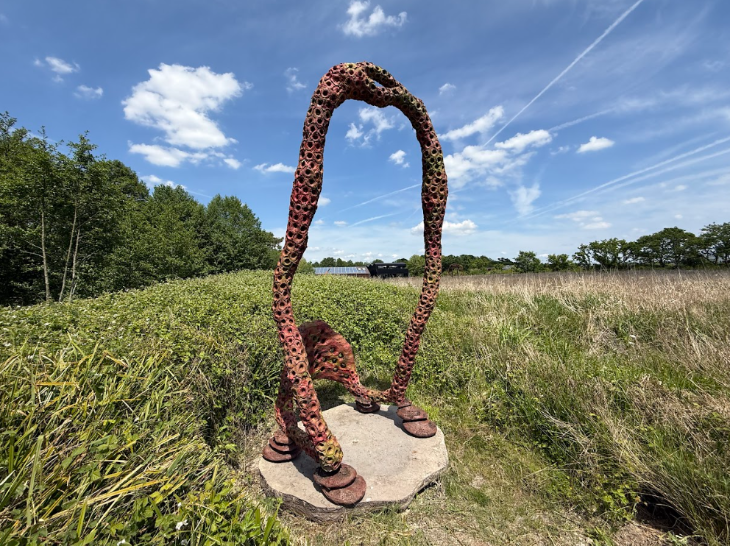 Things to do today in London: an arch-like sculpture in a field