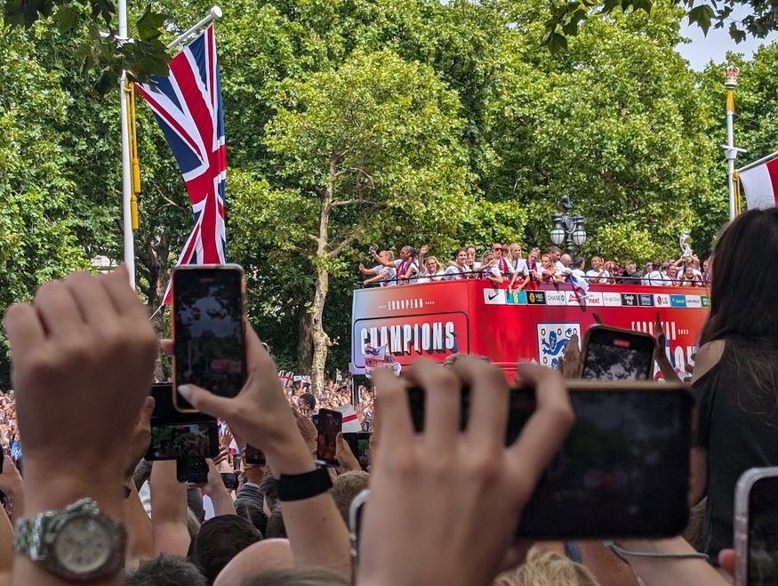 The open top bus driving past