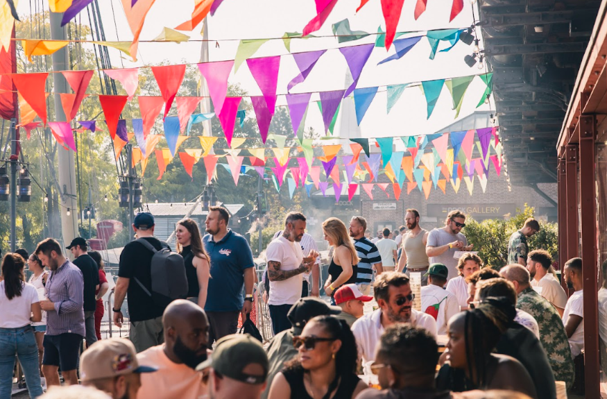 Things to do in London August 2025: people sitting and standing eating and drinking beneath colourful bunting