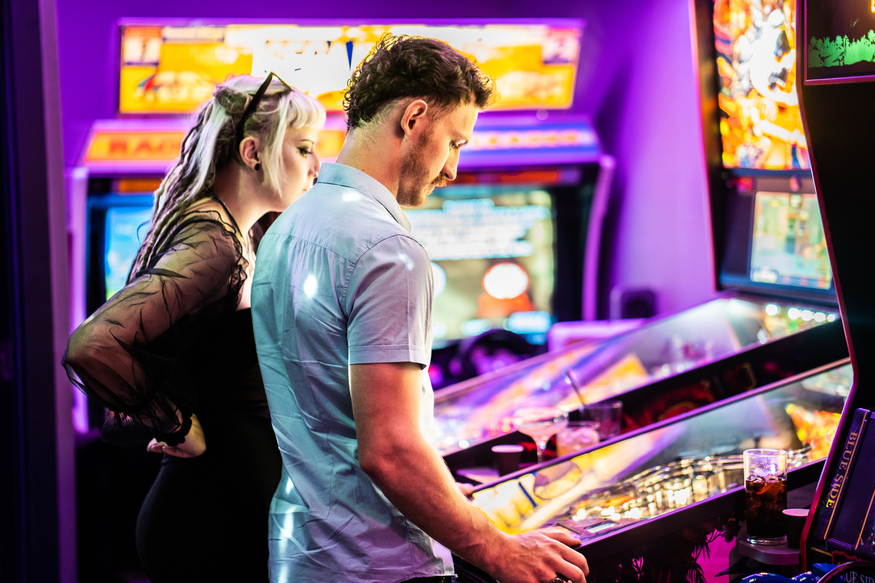 A couple playing an arcade game