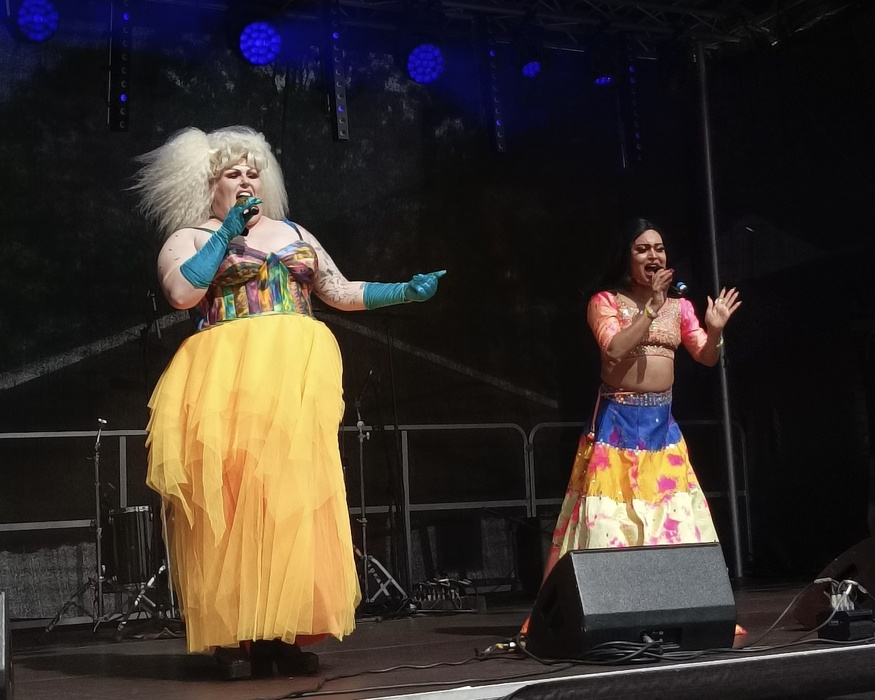 Two drag artists singing