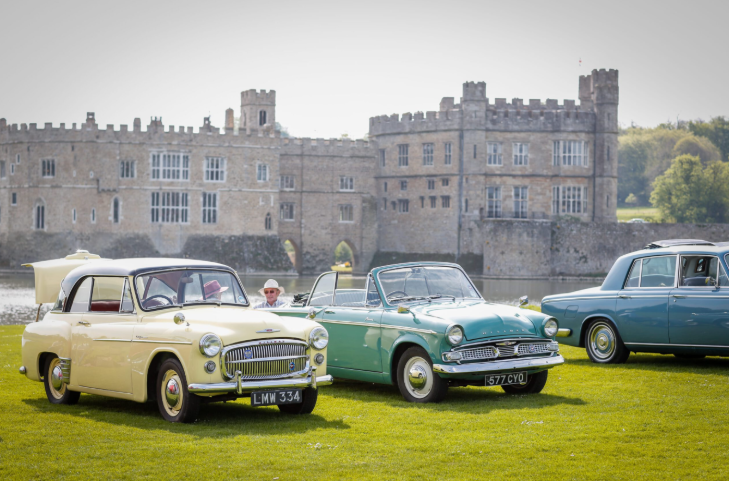 August day trips from London: classic cars parked by the moat at Leeds Castle