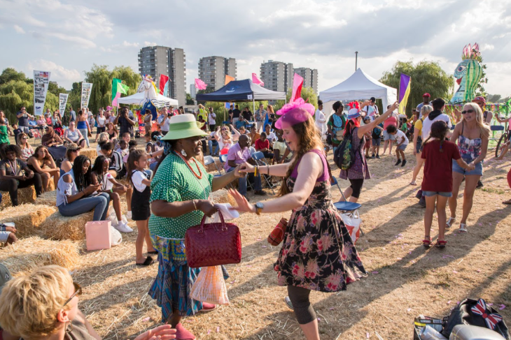 Two women dancing hand in hand at Thamesmead Festival