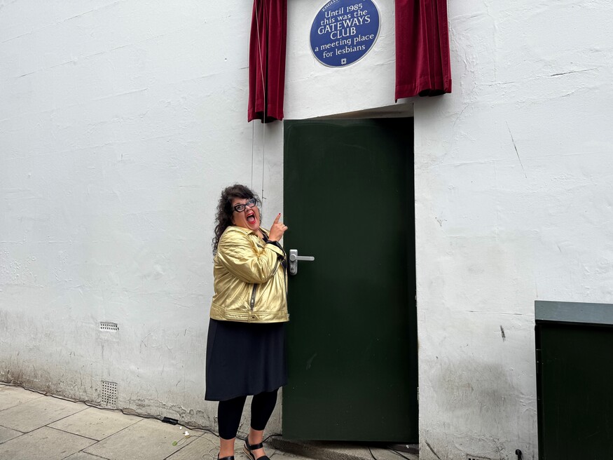 A plaque is unveiled above a green door