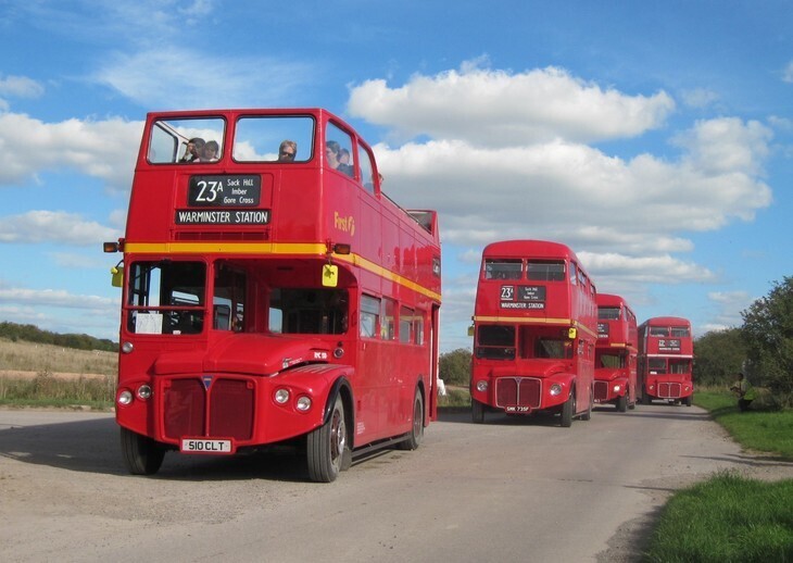 August day trips from London: a parade of red double deckers taking part in Imberbus
