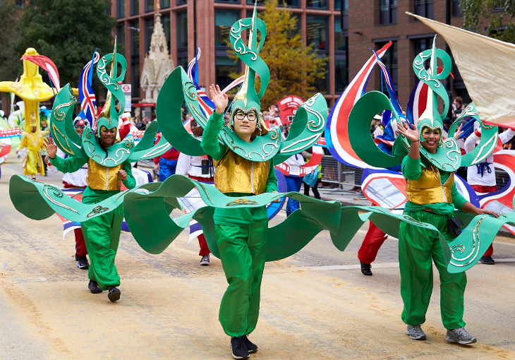 Lord Mayor's Parade 2025: Performers in colourful green costumes waving at the camera