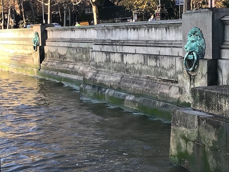 Two lion mooring rings on embankment