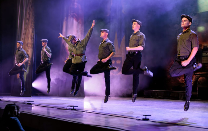 Dance performance on a purple stage at the peacock theatre in London