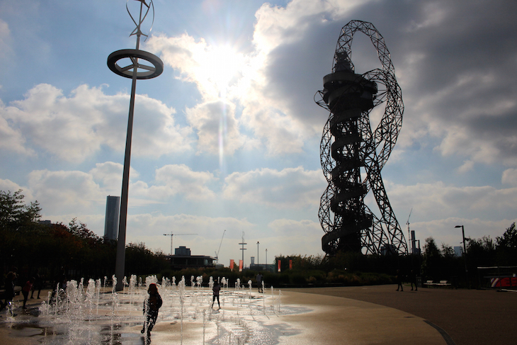 Play fountains in London: children running through fountains in the shadow of the ArcelorMittal Orbit