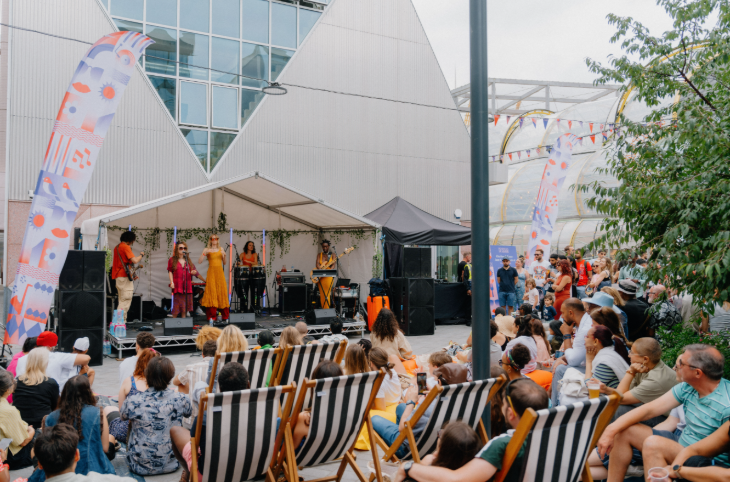 This weekend in London:  People sitting in deckchairs watching live music on stage