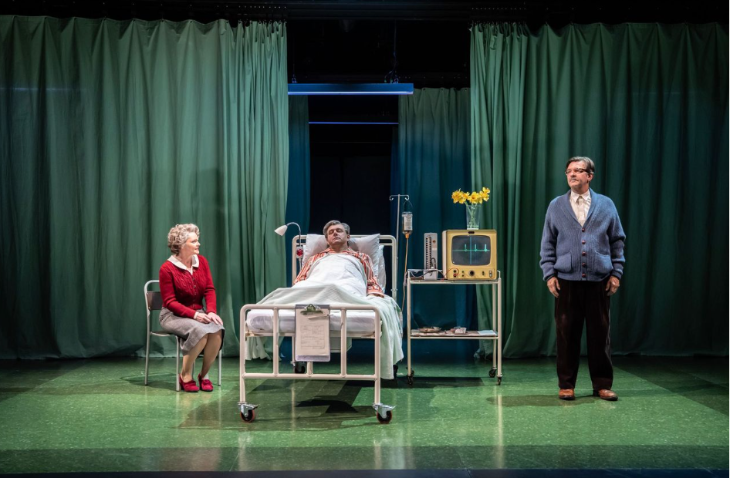 Things to do in London this weekend:  the cast of Nye in a scene featuring  a man in a hospital bed