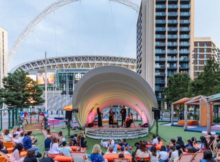 Things to do today in London: people watching an open-air concert in front of the Wembley Stadium arch