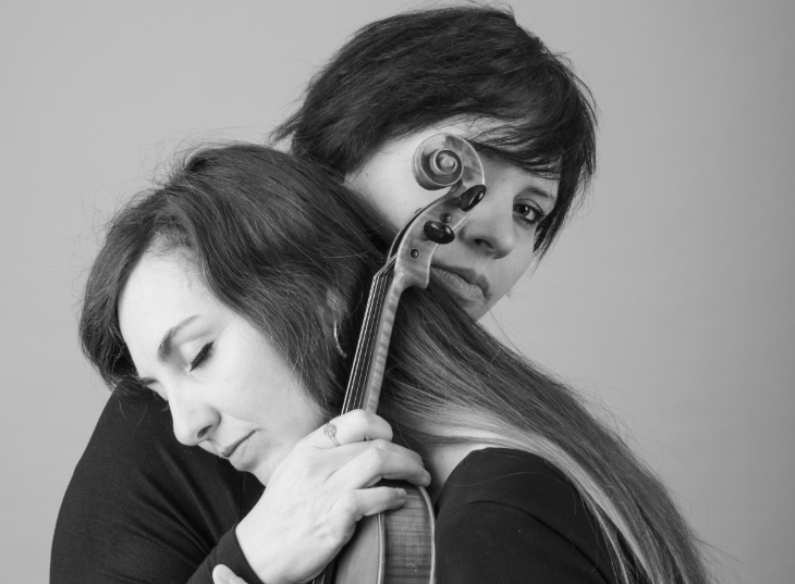 Things to do today in London:  a black and white photo of two musicians embracing, one holding a violin
