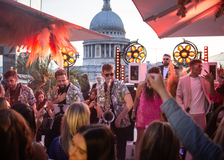Things to do today in London: a band performing in an open-air bar, with the dome of St Paul's in the background