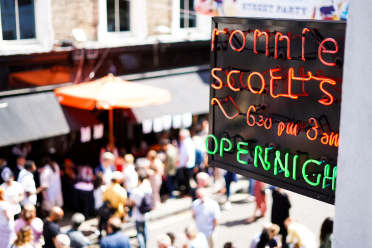 Things to do in London this weekend: people in the streets below the Ronnie Scott's Jazz Club sign