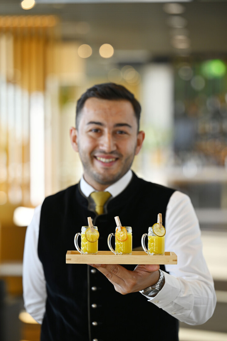 A server holding out a tray of drinks