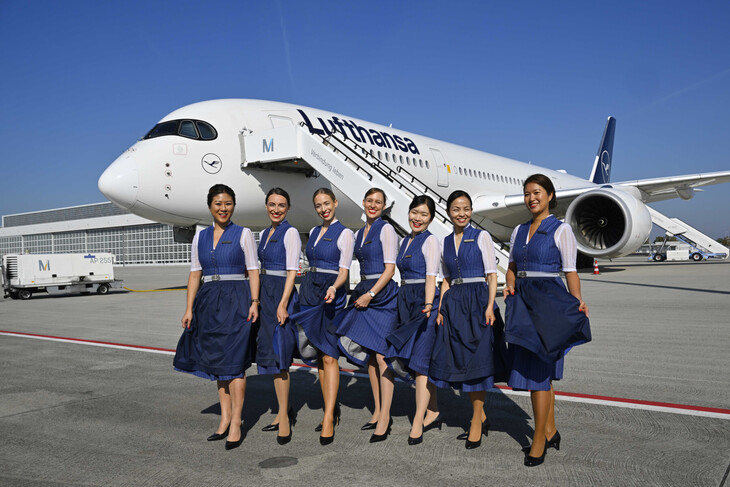 Staff lined up in front of the plane