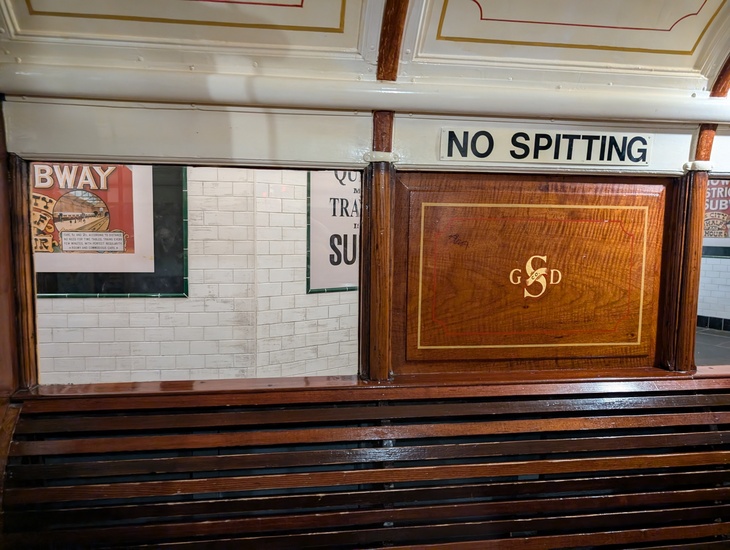 An old subway train with a sign: No spitting