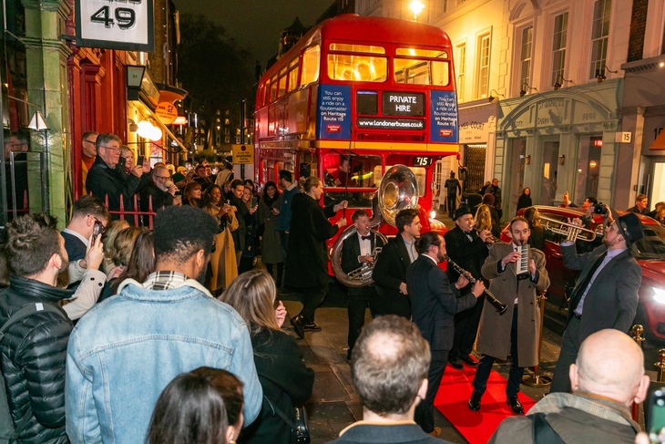 Jazz musicians on the streets next to a vintage double decker