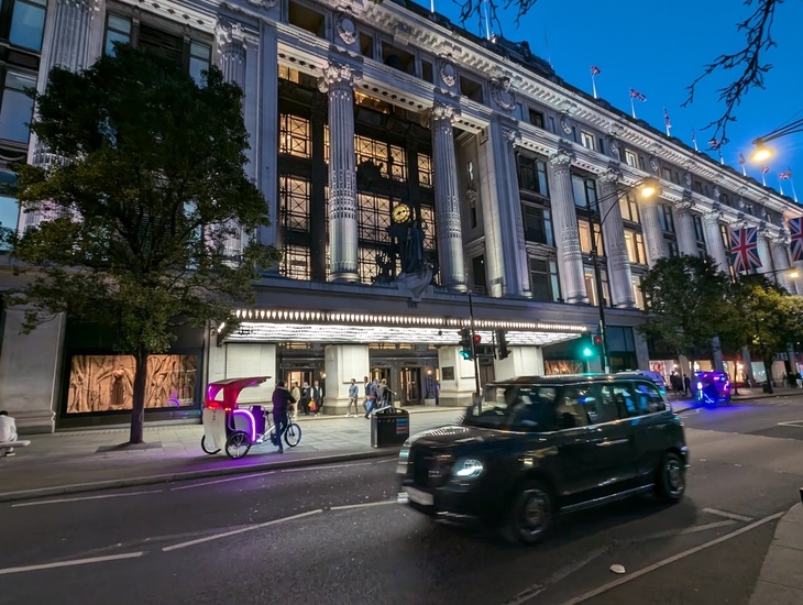 A taxi driving past Selfridges