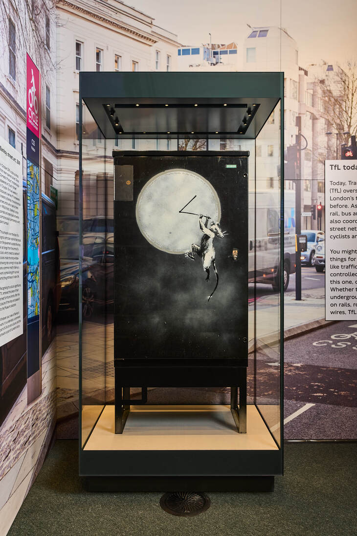 The artwork on display in a glass vitrine