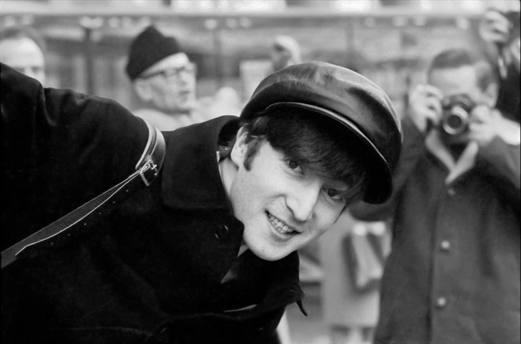 John Lennon grinning at the camera
