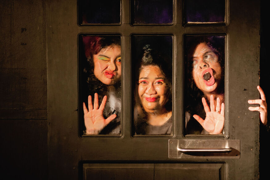 The Bitches in Stitches performers pressing their faces against glass