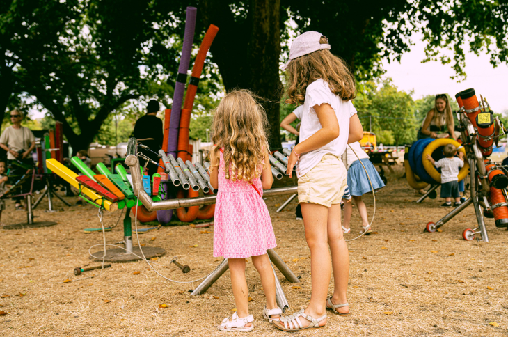 Free and cheap London events: children playing with musical instruments at an open-air festival