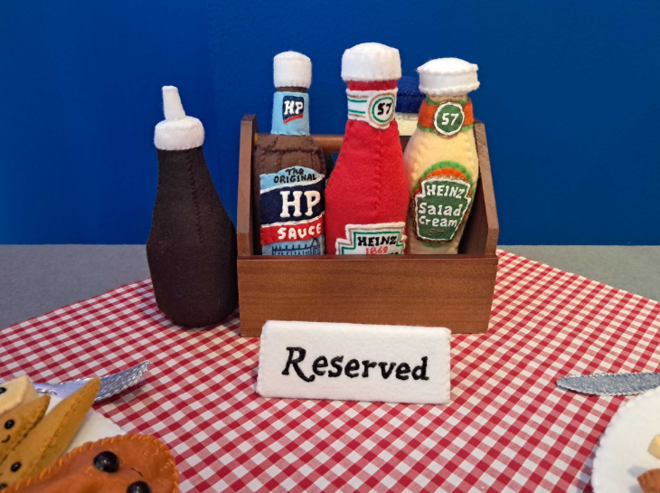 Free and cheap London events: a condiments rack with ketchup, HP Sauce, salad cream and vinegar, all made from felt