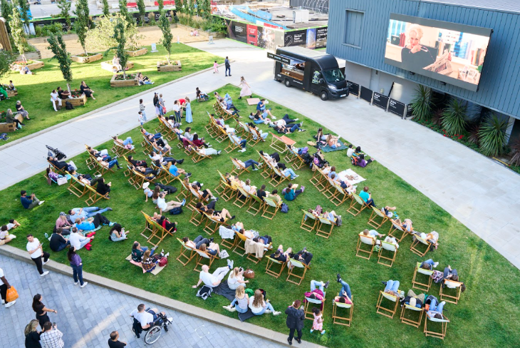 Free events in London: people sitting on deckchairs watching a large outdoor screen