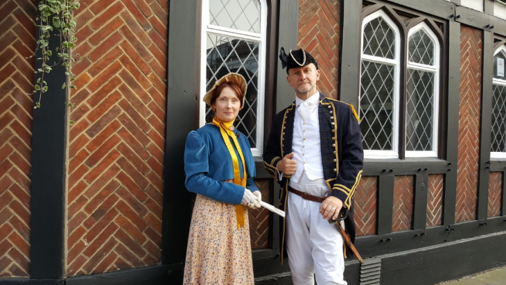 A man and woman dressed in Regency period costume