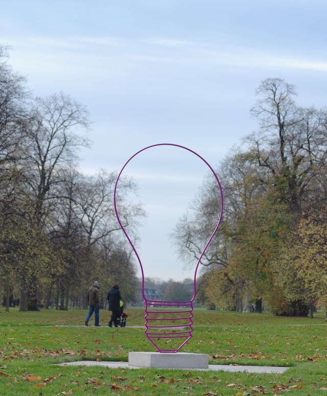 A lightbulb sculpture in a park
