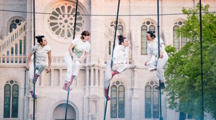 Things to do in London August bank holiday weekend: four performers dressed in white high up on stilt poles