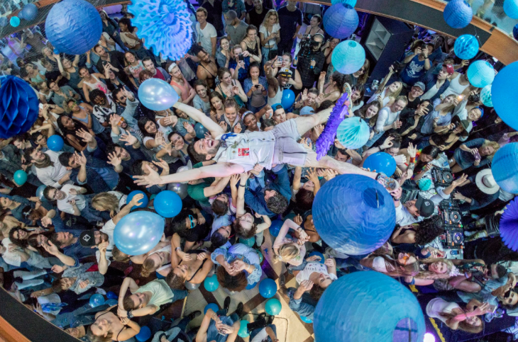 Things to do this weekend in London: a man crowdsurfing at a festival, surrounded by blue balloons