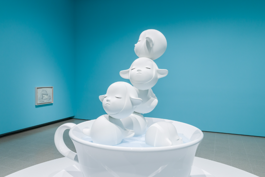 What's on in London today: a white sculpture showing three alien-like creatures emerging from a teacup, against a blue wall backdrop