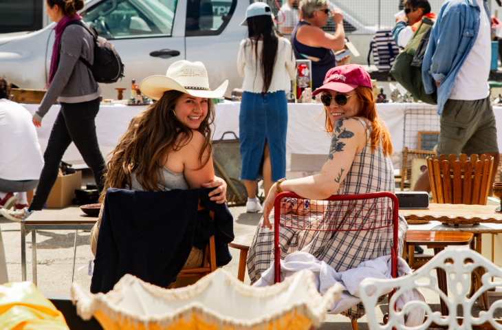 Things to do this weekend in London: two women sitting in chairs and smiling at the camera at a flea market