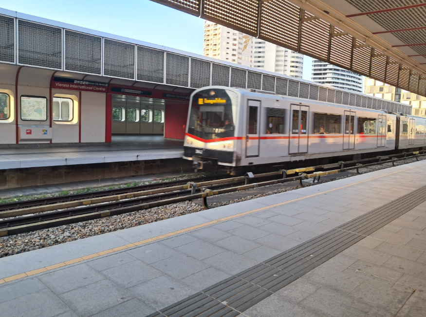 A train pulling into an open-air platform