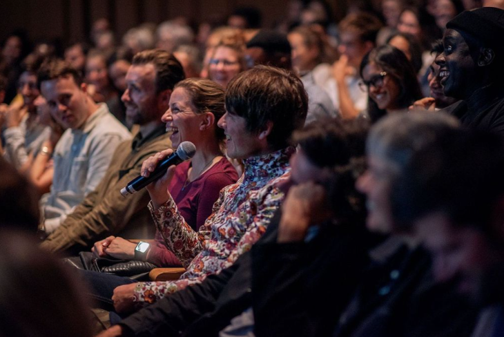 Things to do in London this weekend: an audience member holding a microphone