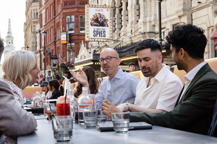 People eating outside a theatre