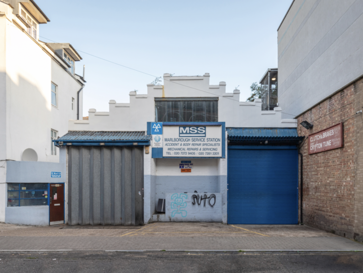 A white garage with a stepped gable