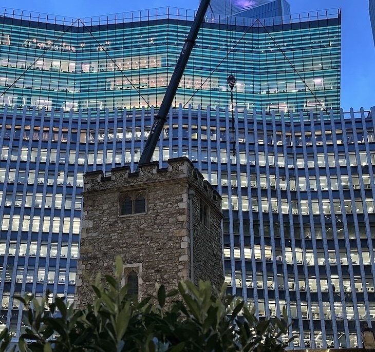 An ancient church in front of a modern high rise
